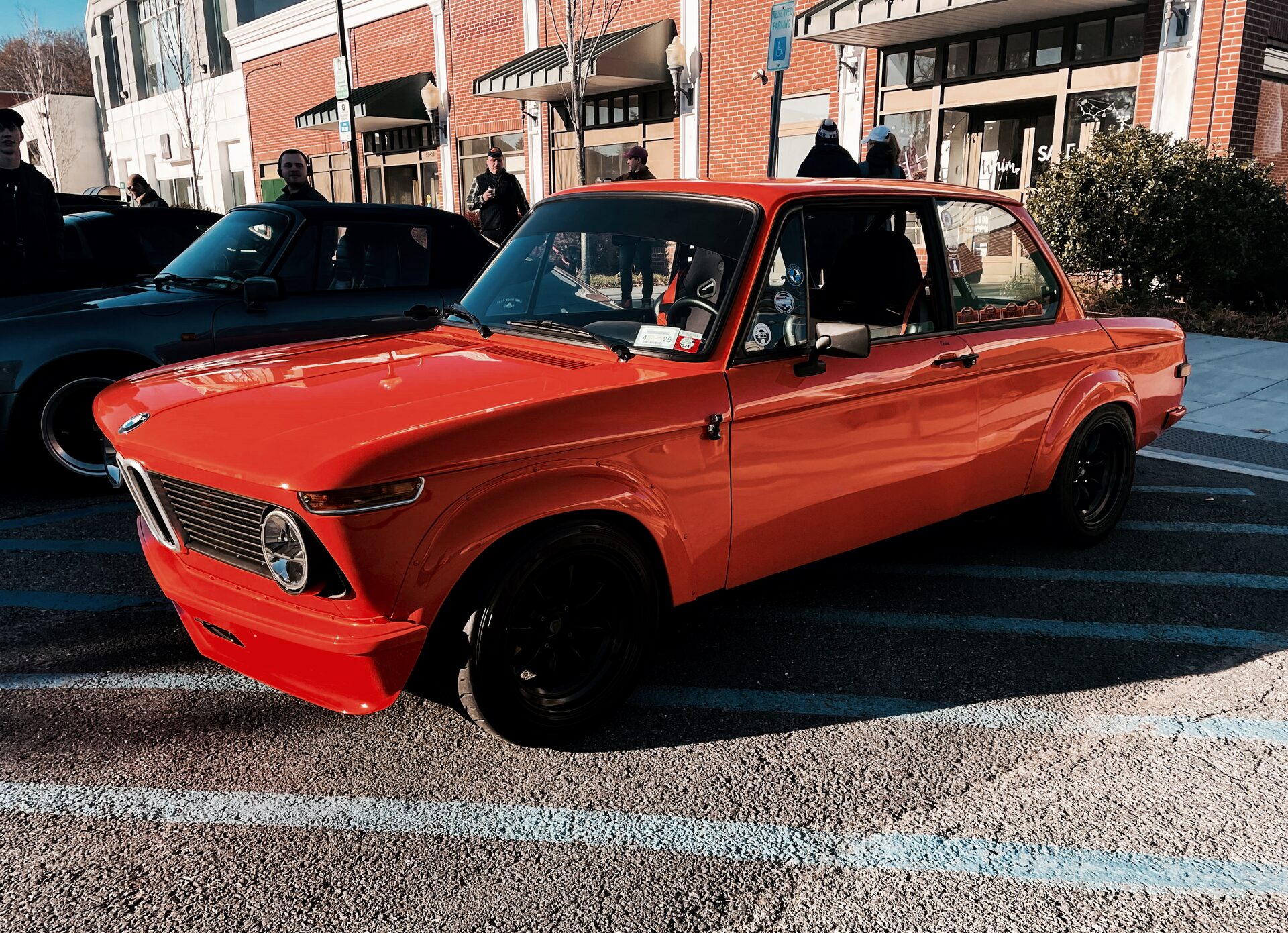Colorado-orange BMW 2002tii in a parking lot, three-quarter view