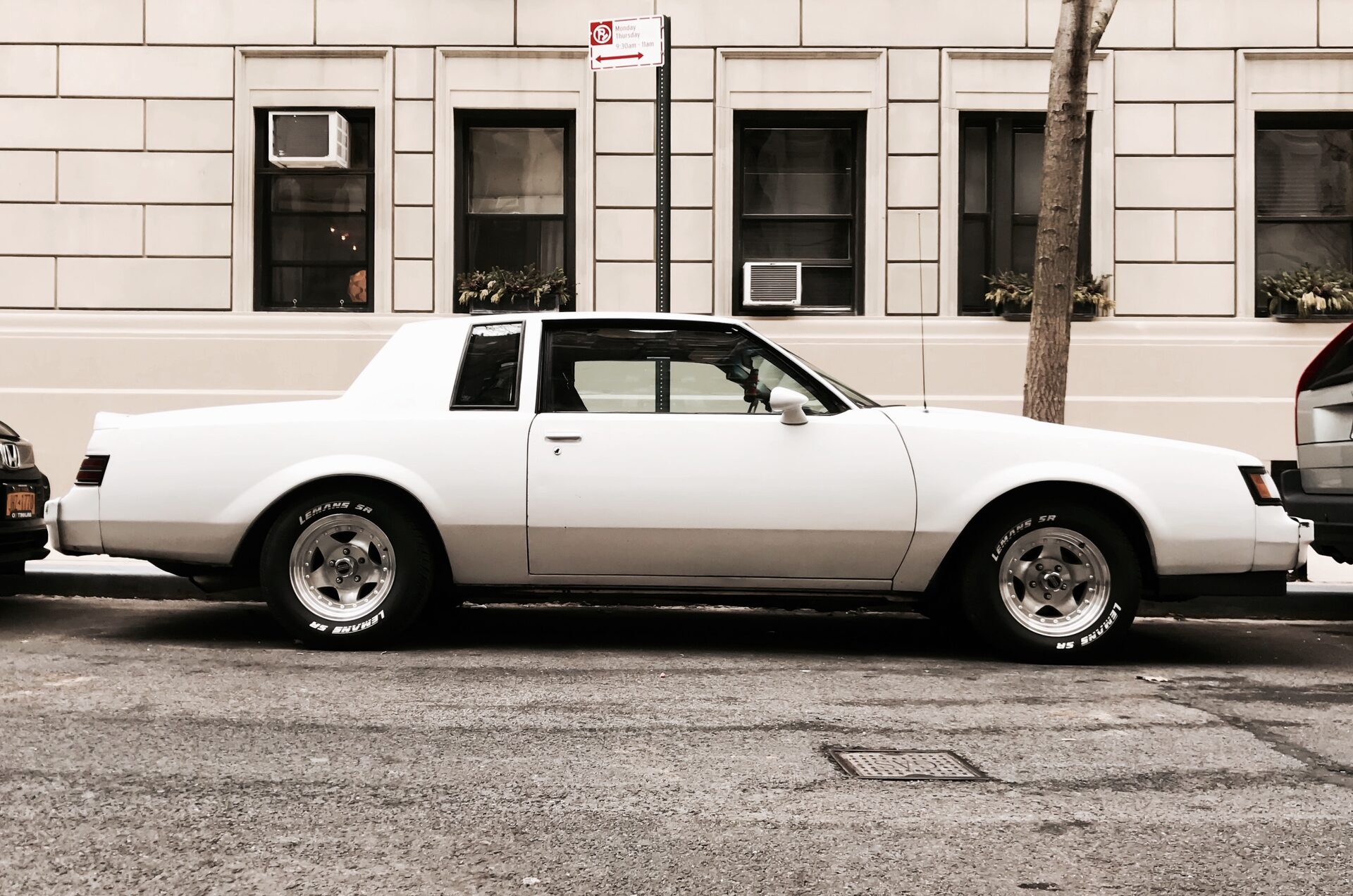 White Buick Regal with two-tone lower trim, parked on a Manhattan street