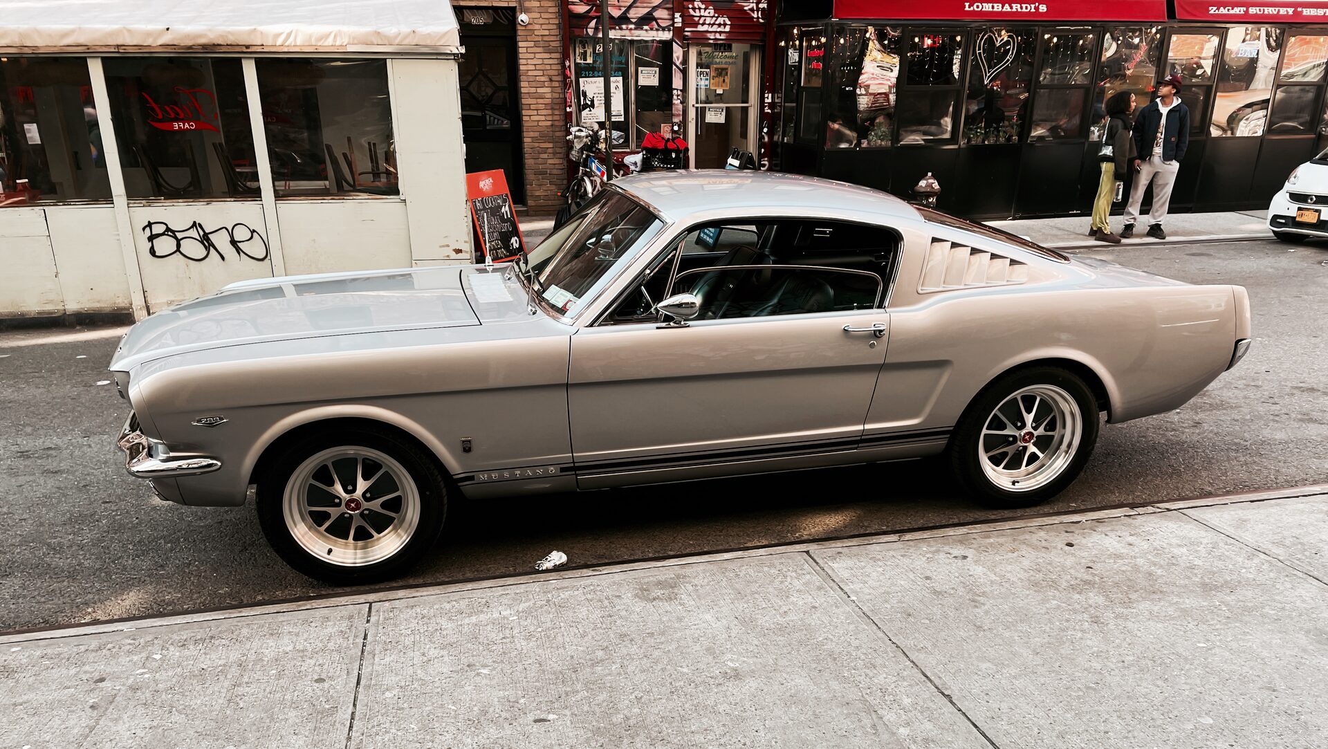 Silver 1967 Ford Mustang fastback, side profile on a Manhattan street