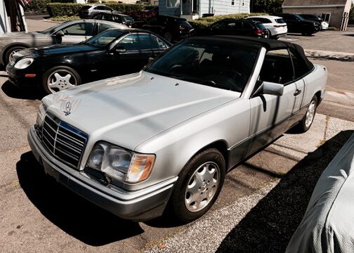 Silver 1995 Mercedes-Benz E320 Cabriolet, front three-quarter left view with the soft top up
