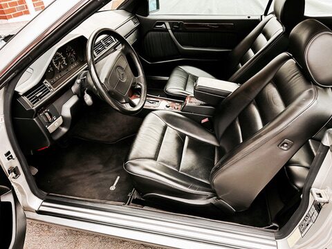 Driver's side interior of the 1995 Mercedes E320 Cabriolet &mdash; black leather seats and steering wheel