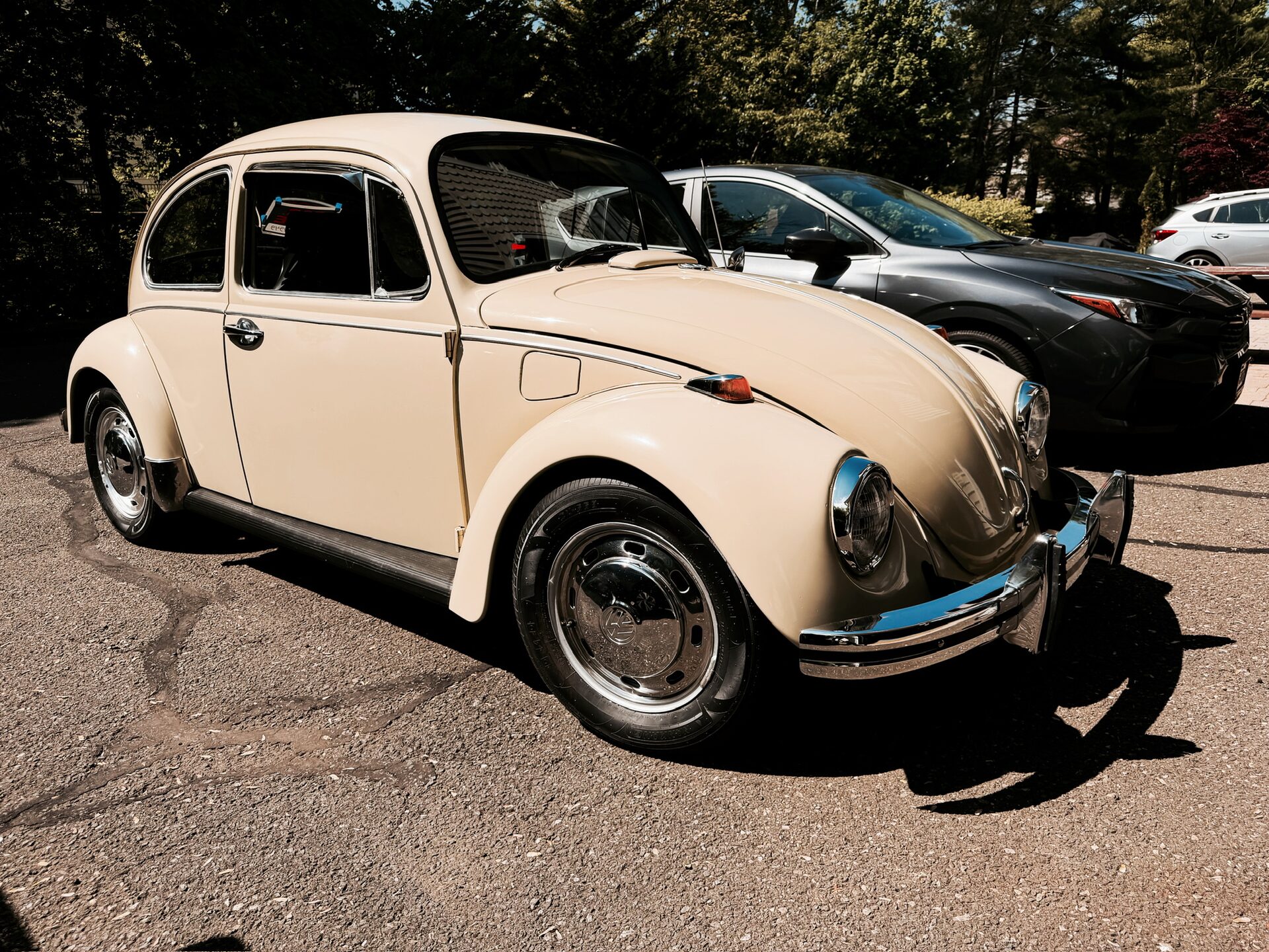 Cream 1969 VW Beetle, front three-quarter right view in a parking lot