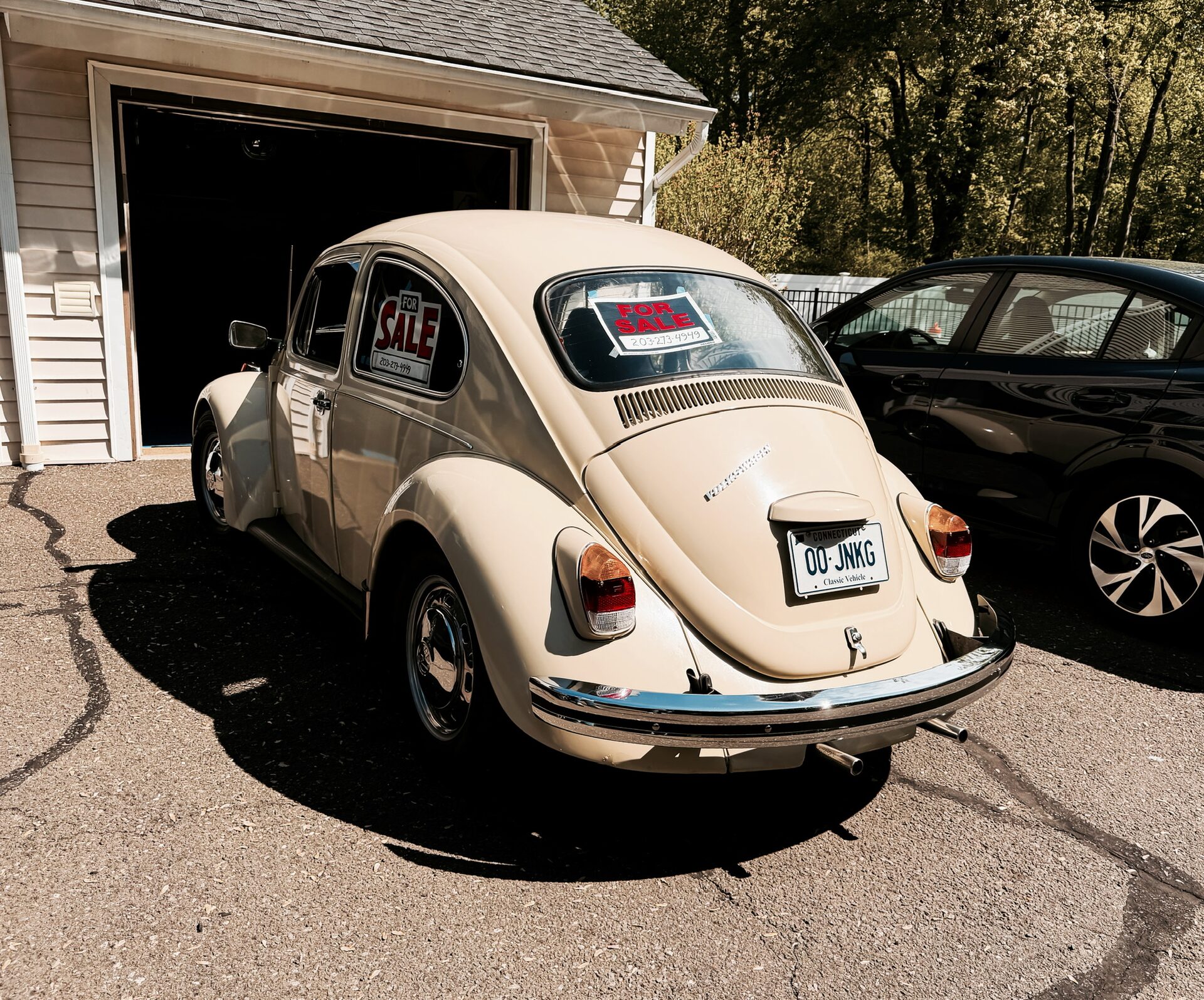 Cream 1969 VW Beetle, rear three-quarter view in front of a garage